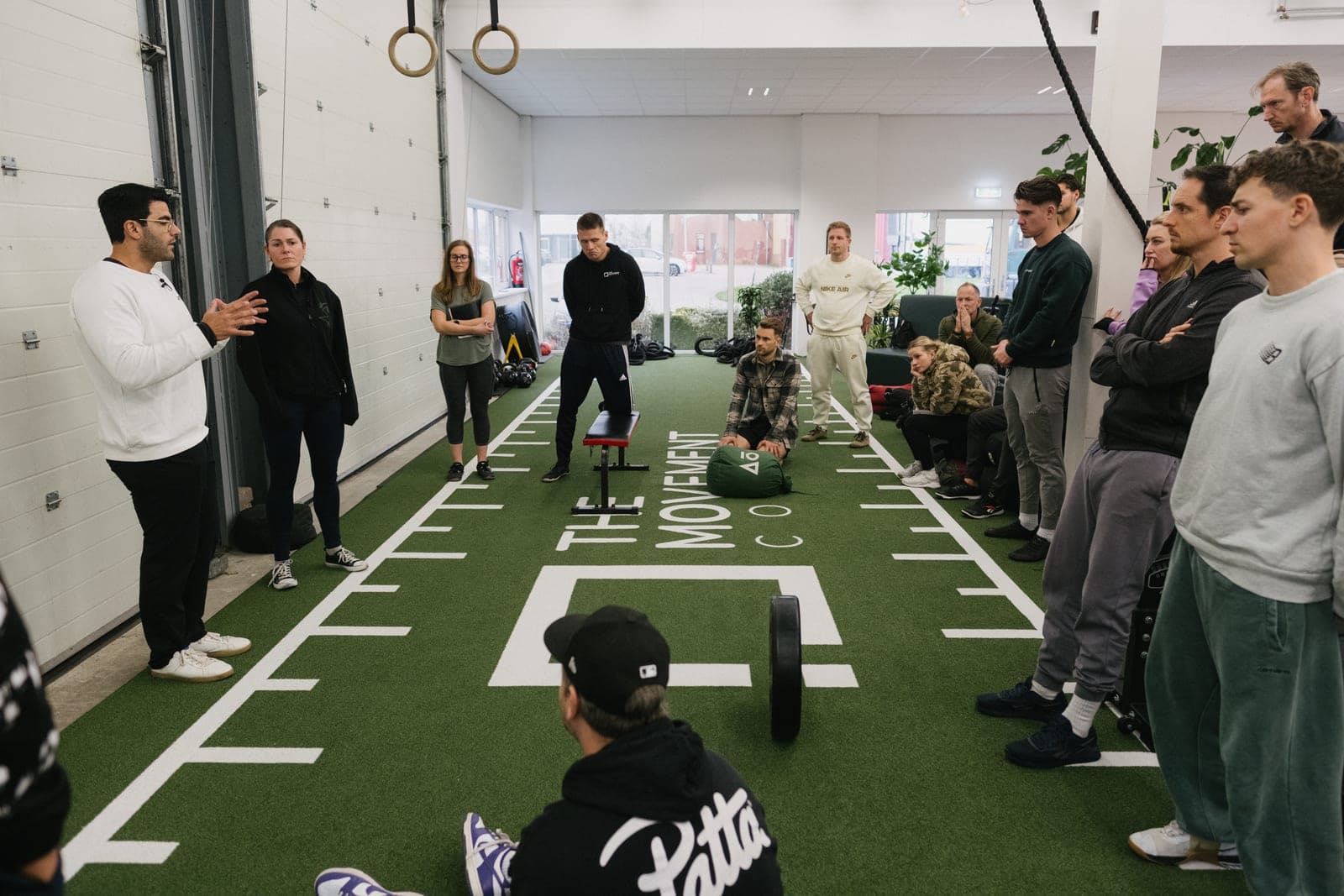 Richard leading a live movement assessment with coaches at a Moved Academy certification seminar