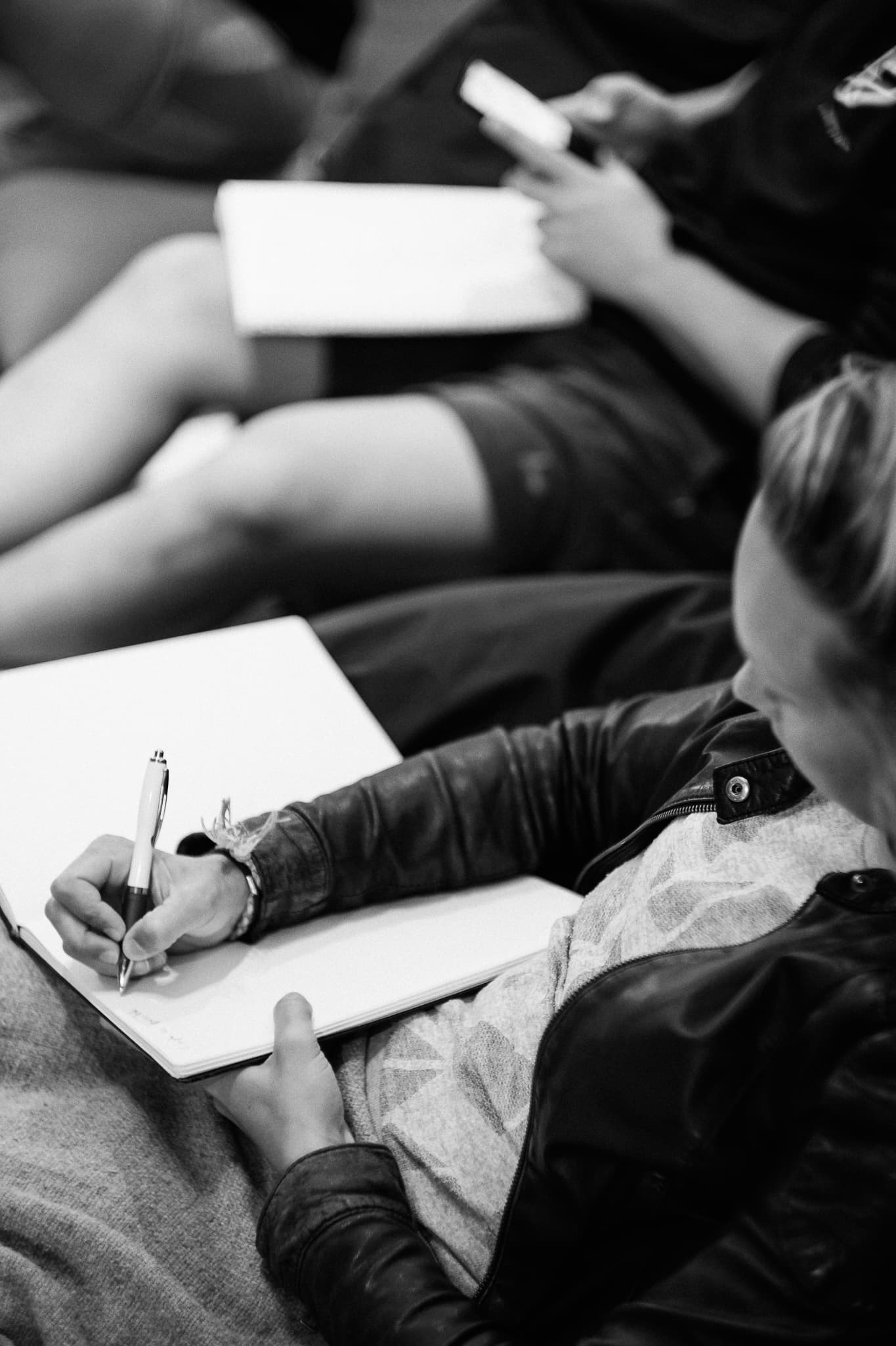 A seminar participant taking notes during a Moved Academy session
