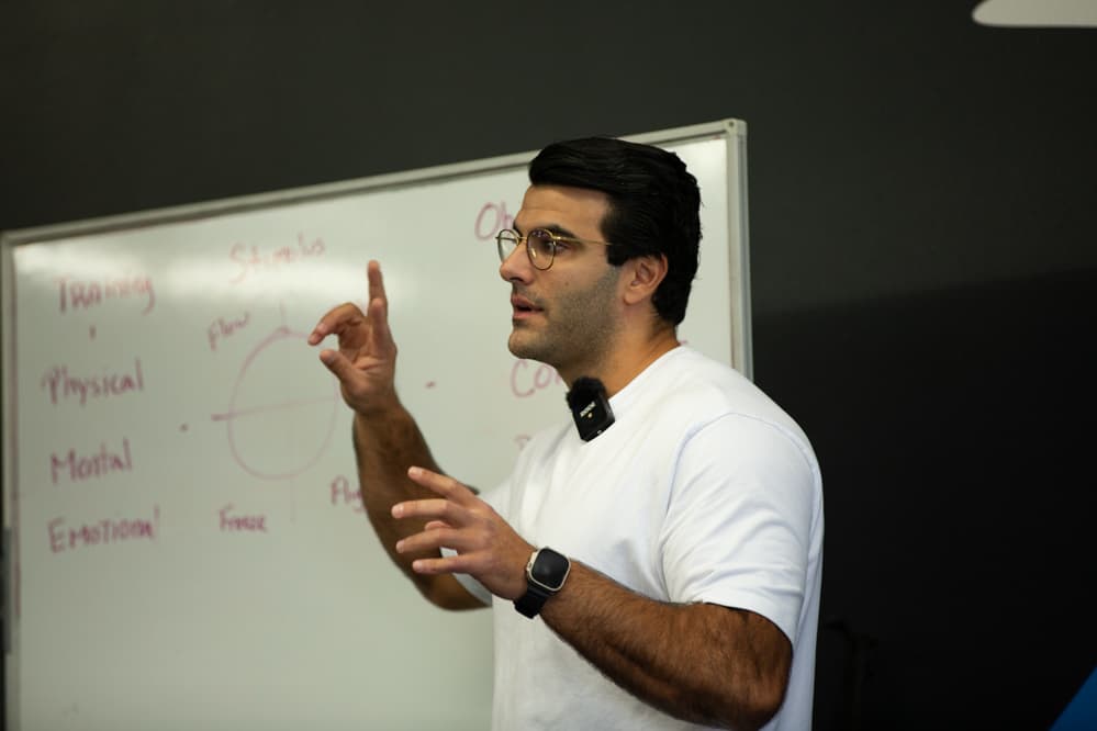 Richard Aceves teaching whole-human coaching concepts at a whiteboard