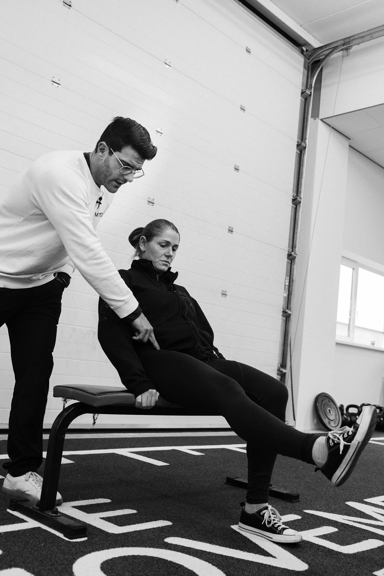 Richard Aceves coaching a participant through a seated movement during an in-person Moved Academy seminar.