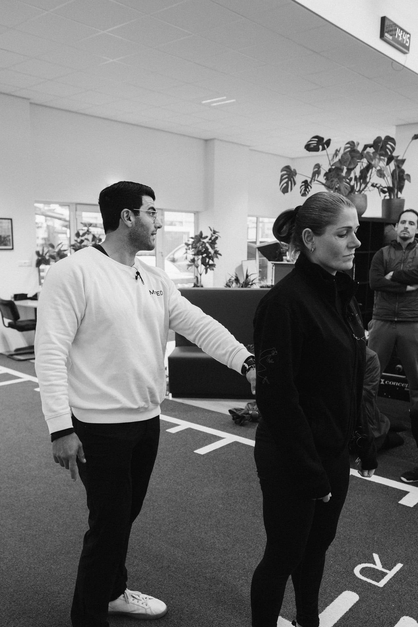 Richard Aceves coaching a movement assessment hands-on